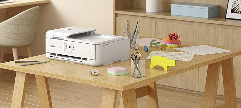 White Printer and objects on table