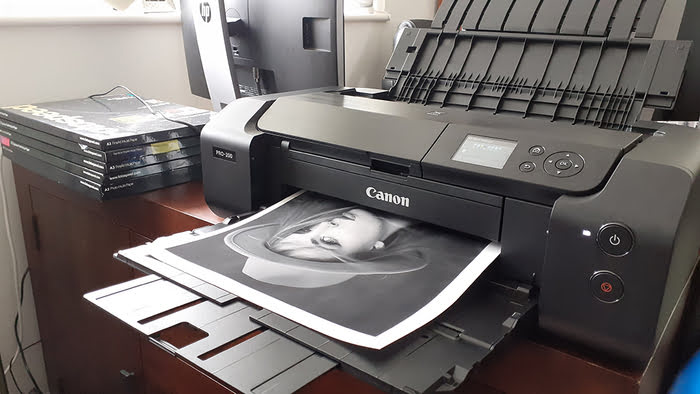 black canon printer printing out an image